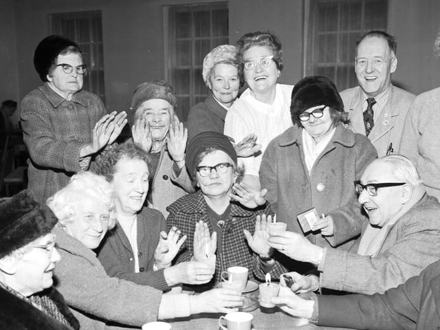 Old people at Dalry House warming up with candles.