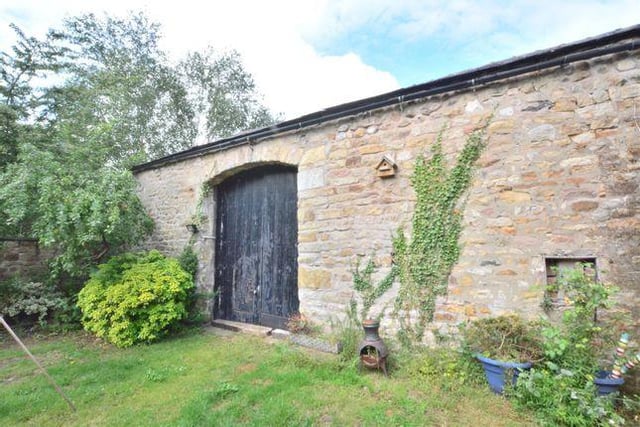 The Old Coach House in the garden offers scope for development.