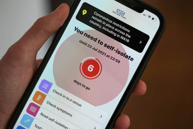 Illustration of a smartphone using the NHS Covid-19 app alerts the user "You need to self-isolate" on July 18, 2021. (Photo illustration by Christopher Furlong/Getty Images)