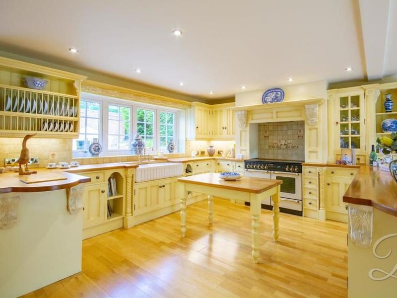The impressive kitchen diner comes complete with traditional cabinets and units, work surface, sink and drainer with a mixer tap above, and double integral ovens. There is a window at the back, a cupboard for additional storage and central heating radiators.