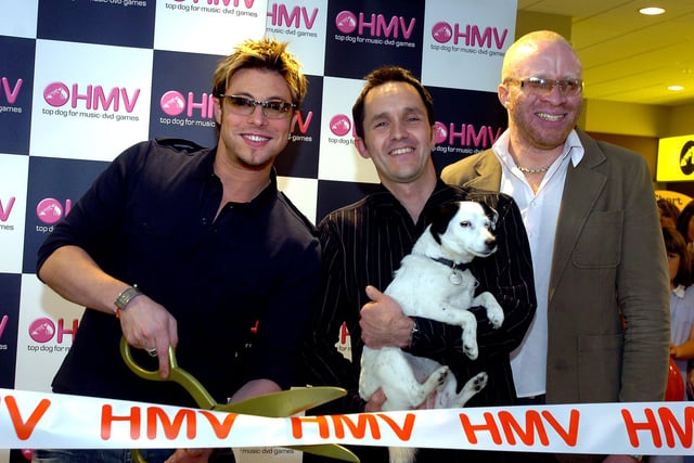 Duncan James, former singer with pop band Blue, cut the tape to officially open the new HMV store in 2006. Looking on are shop manager Andy Baxter, HMV dog, Nipper, and Trax DJ CK.