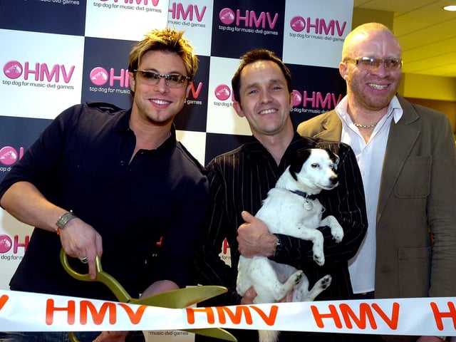 Duncan James, former singer with pop band Blue, cut the tape to officially open the new HMV store in 2006. Looking on are shop manager Andy Baxter, HMV dog, Nipper, and Trax DJ CK.