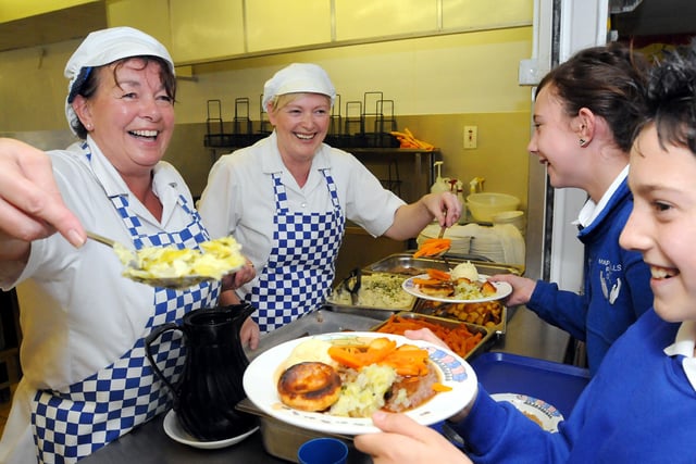 Amber Walker and Sam Holder pupils from Mapplewells School in Sutton had their school dinners served by kitchen staff Susan Moore and Pat Berry as part of an attempt to cook as many dinners as they can to break a world record
