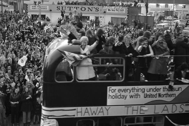 All smiles on the parade and there's Sutton's in the background. Remember it?