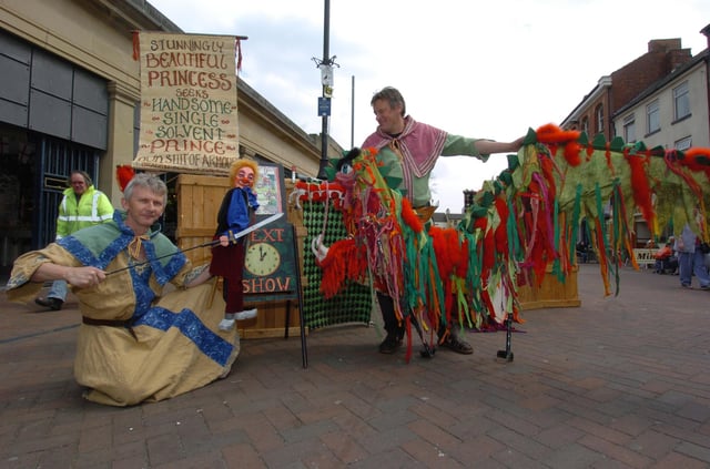 Mel Myland and Tony Nicholson entertain shoppers in Doncaster with their puppet show telling the tale of St George and the Dragon