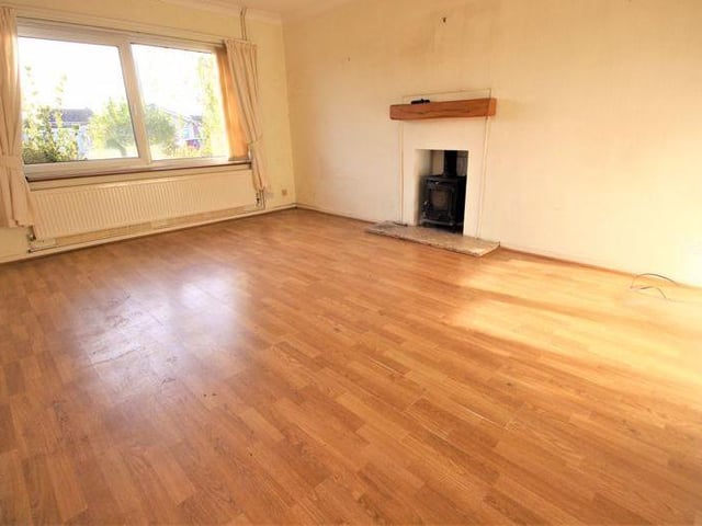 An entrance porch leads into a hallway which, in turn, guides you towards this sizeable lounge, which features a solid-fuel burner with marble hearth and wooden mantelpiece. There is also laminate flooring, a radiator, uPVC window to the front of the house and twin decorative ceiling-lights with dimmer switch.