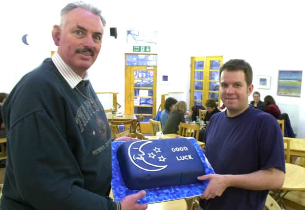 Nick Dunhill (right) of the Blue Moon cafe pictured presenting a Vegan cake to  Geoff Usher of HARC in 2001