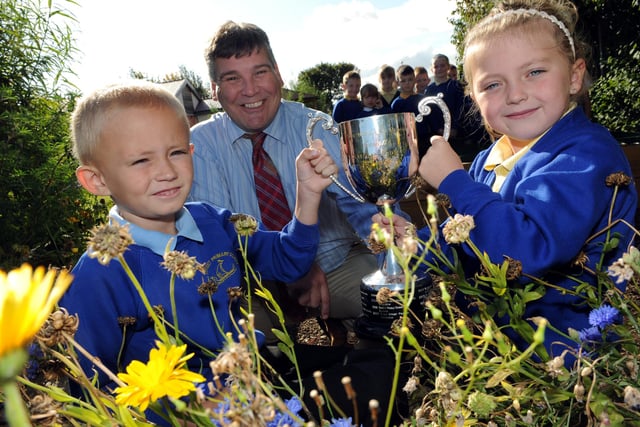 The school's amazing record for floral splendour is shown to great effect in this 2011 photo. It shows pupils with their Northumbria in Bloom award.