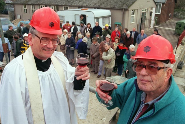The Vicar of Bakewell The Reverand Edmund Urquhart toasted the success of  the new Medway Centre in Bakewell in 1998 at a topping out ceremony also pictured is project coordinator Alan Pigott and volunteer builders looked on