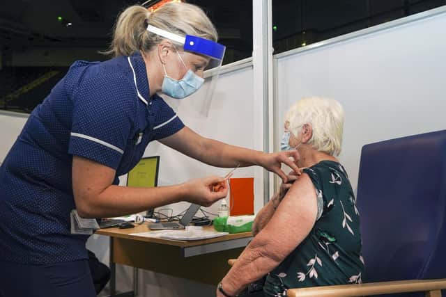 Sally Conlan Deputy Nurse Director for the Covid 19 Vaccination Programme vaccinates Rita Moss at the Covid 19 max vaccination centre which has opened at the Sheffield Arena.