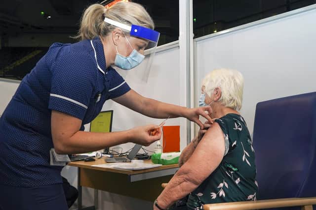Sally Conlan Deputy Nurse Director for the Covid 19 Vaccination Programme vaccinates Rita Moss  at the Covid 19 max vaccination centre which has opened at the Sheffield Arena.