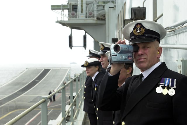 HMS Ark Royal officer videotapes the aircraft carrier's entry into Portsmouth Harbour 15th march 2003. Picture: Jonathan Brady 032429-165