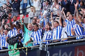 LONDON, ENGLAND - MAY 29: Liam Palmer and Barry Bannan of Sheffield Wednesday celebrate while holding the trophy alongside their teammates after the team's victory and promotion to the Sky Bet Championship in the Sky Bet League One Play-Off Final between Barnsley and Sheffield Wednesday at Wembley Stadium on May 29, 2023 in London, England. (Photo by Catherine Ivill/Getty Images)