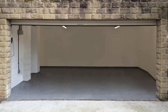 This is the double garage - it has an electric roller shutter door, built-in storage, automatic strip lighting, power supply and a personal entrance door.