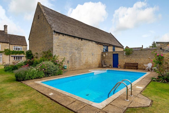 The farmhouse is surrounded by private walled gardens and boasts its own outdoor swimming pool, complete with a stone terrace and an outdoor seating area.