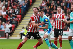 Tom Lawrence grapples with former Sheffield United loanee Ben Davies: Simon Bellis / Sportimage