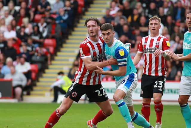 Tom Lawrence grapples with former Sheffield United loanee Ben Davies: Simon Bellis / Sportimage