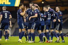 John McGinn celebrates after he makes it 2-2 with Che Adams (left) during a World Cup qualifier between Scotland and Austria at Hampden Park