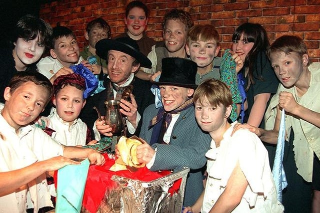 "Fagin", Tim Bruddock, with" Oliver", Joseph Baxter, and "The Dodger", Ben McErlain, with members of the 'gang' in the Westbourne School's production of Oliver, March 1998