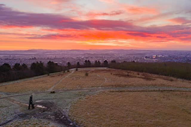 Sunrise over a dog walker on the hills above the town. Photo: Paul Atherley