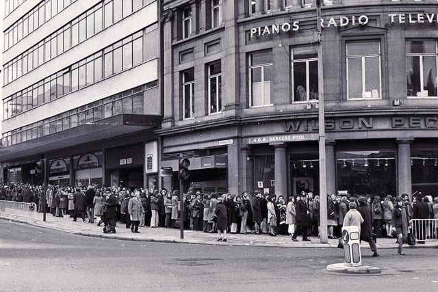 A long queue outside Wilson Peck, which sold all things musical, on the corner of Barkers Pool and Leopold Street, in Sheffield city centre, in April 1973