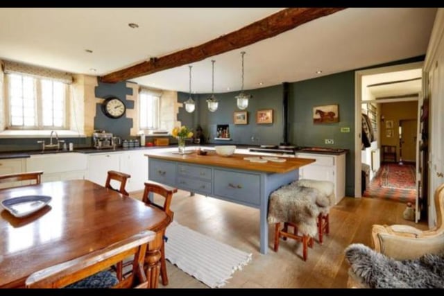 The kitchen offers a rustic charm with its fitted, bespoke wood units and oak work surfaces. It also boasts a double oven oil-fired Aga, perfect for making hearty winter dishes. The oak floor and French doors opening out into the garden add extra style to this already beautiful room.