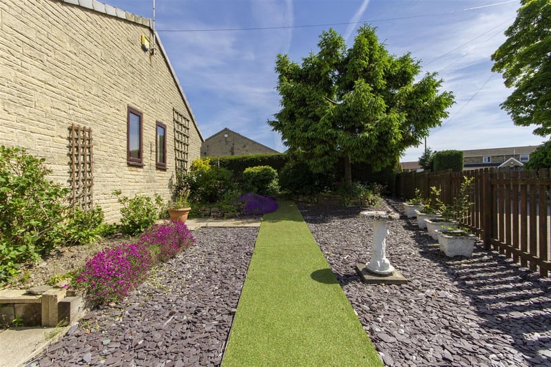 To the side of the property there is a low-maintenance garden comprising of plum slate beds, artificial lawn path and raised beds and borders filled with various plants and shrubs.