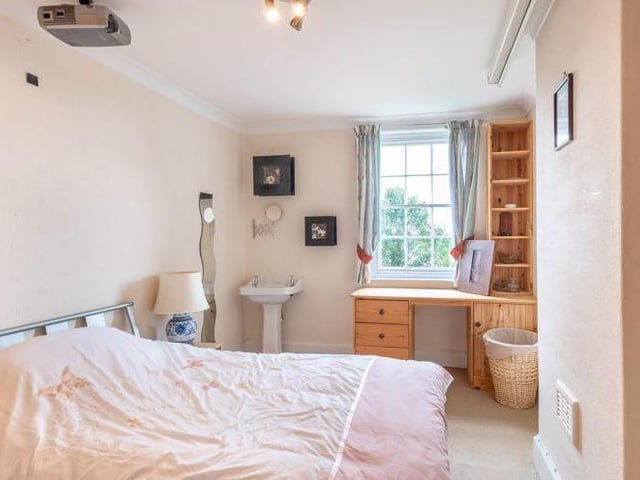 The property boasts a plethora of bedrooms. In the main house, there are six in total, including this one, while the extension includes a further two.