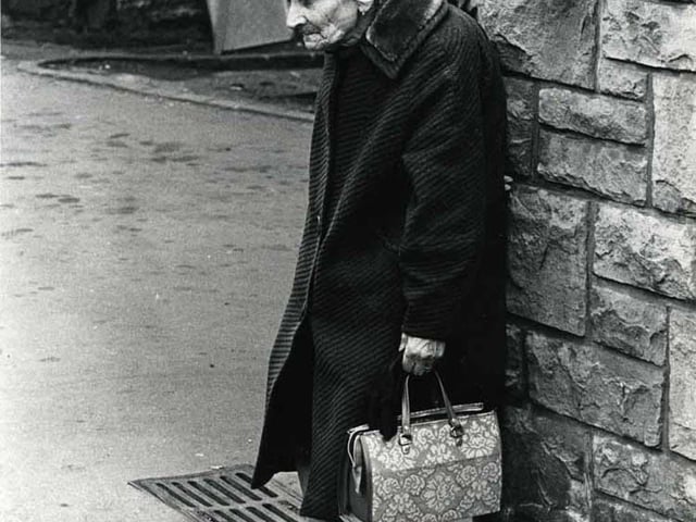 An elderly lady takes a rest in an Edinburgh street.