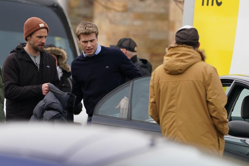 Ed McVey gets into a car as he plays the part of Prince William as they film scenes for the next season of The Crown in St Andrews. On Wednesday, actor Ed McVey, 21, who will play the prince throughout his late teens and early 20, and Dominic West, 53, who is playing Charles, carried on with work on the sixth series.
