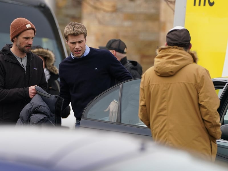 Ed McVey gets into a car as he plays the part of Prince William as they film scenes for the next season of The Crown in St Andrews. On Wednesday, actor Ed McVey, 21, who will play the prince throughout his late teens and early 20, and Dominic West, 53, who is playing Charles, carried on with work on the sixth series.