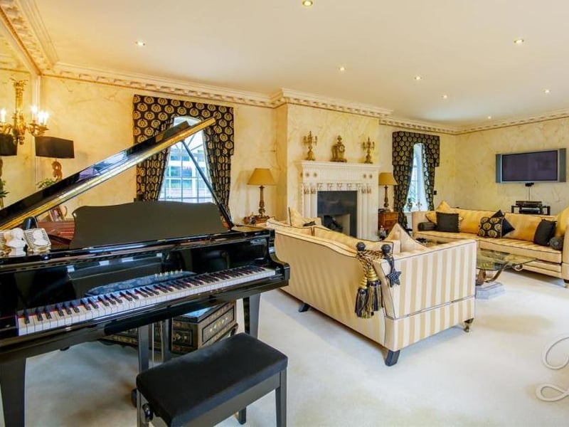 A look at the drawing room, which oozes class and elegance. It includes a carpeted floor, feature fireplace and five windows offering lots of natural light.