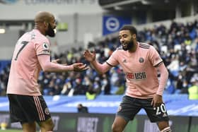 Sheffield United's Jayden Bogle, right, celebrates after scoring the opening goal during the English Premier League soccer match between Brighton and Hove Albion and Sheffield United at the American Express Community Stadium in Brighton, England, Saturday, Dec. 20, 2020. (Glyn Kirk/Pool via AP)