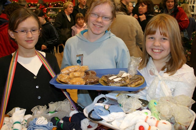 Guides Susie Budd, and Laura and Sophie Keable with a selection of home crafts for sale at the Buxton Dickensian Market in 2007