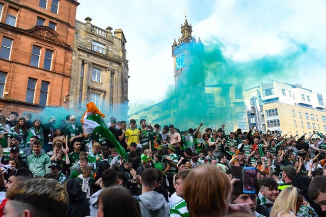 Green smoke bombs are let off by supporters as the celebrations continue