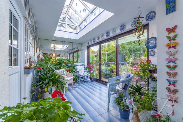 This eye-catching garden room has a skylight and sliding doors.