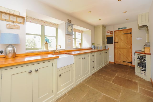 The bespoke kitchen has a Belfast sink and solid wood worktops.
