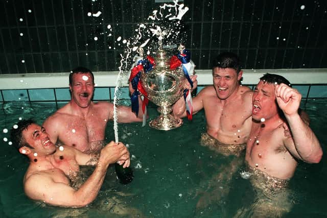 Whetu Taewa, Paul Broadbent, Mark Aston and Paul Carr celebrate the Challenge Cup victory in the famous Wembley bath. Photo: Paul Chappells