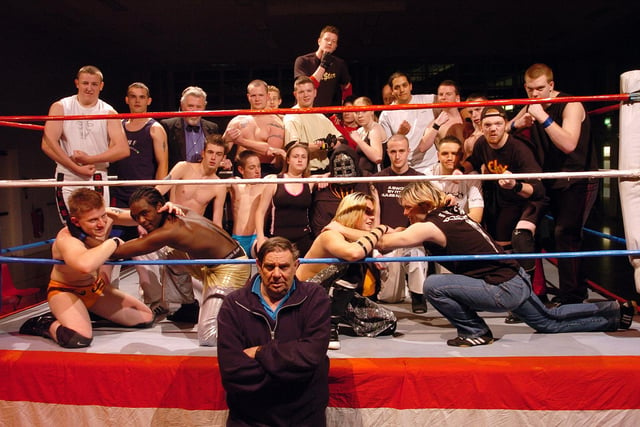 2004. Elite Wrestling Federation promoter John Copping (front) with dozens of wrestlers taking part in the Wrestling Special in aid of BBC Children in Need, held at Admiral Lord Nelson School, Dundas Lane, Portsmouth.
Picture: Michael Scaddan (045706-0044)