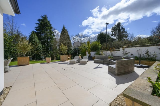 The gardens surrounding this property are covered in vast lawn areas and practical paved spaces.