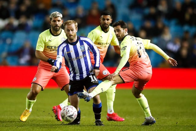Barry Bannan, described post-match by Pep Guardiola as an incredible player, in a fight for possession with Bernardo Silva.