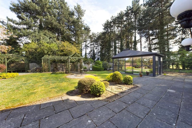 Beautiful gardens with a self contained external home office with sealed unit double glazed panels, power and lighting.