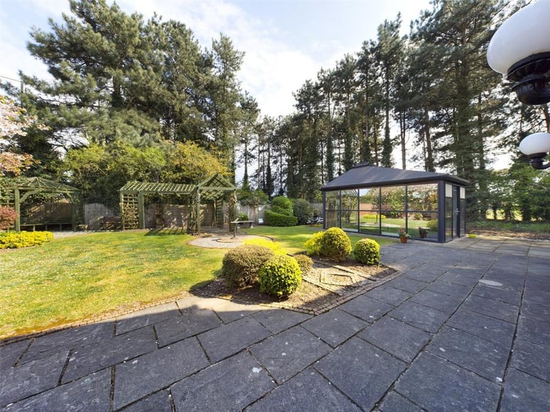 Beautiful gardens with a self contained external home office with sealed unit double glazed panels, power and lighting.