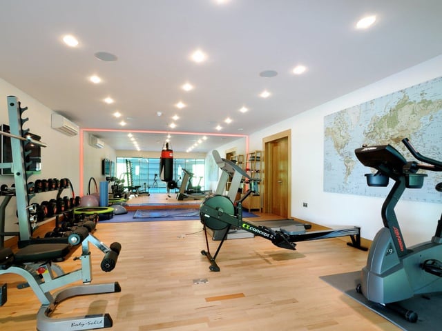 Adjoining the pool is a modern home gym, which is large enough to accommodate several machines and workout equipment.