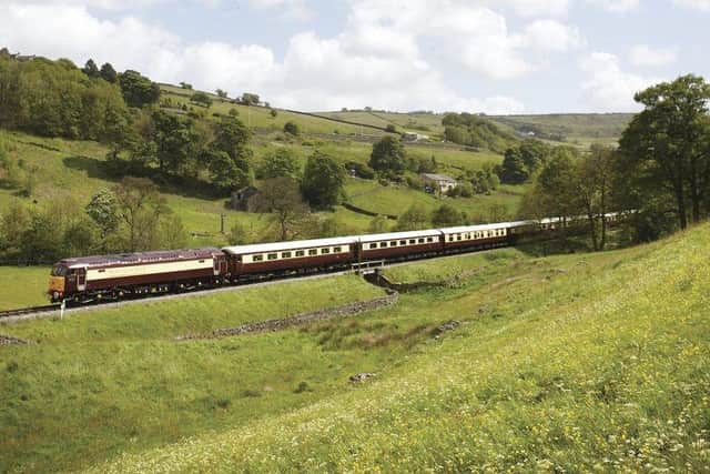 A heritage diesel locomotive takes the Northern Belle through the English countryside