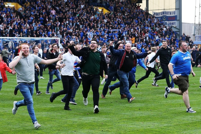 Fans invade the pitch after the 6-1 victory.