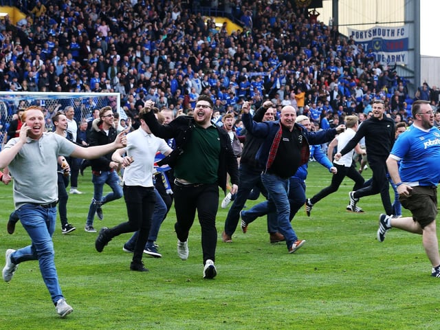 Fans invade the pitch after the 6-1 victory.