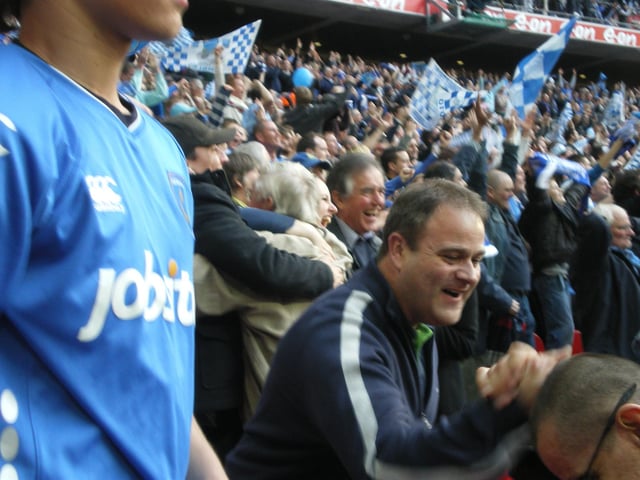 Pompey fans celebrate their side scoring.