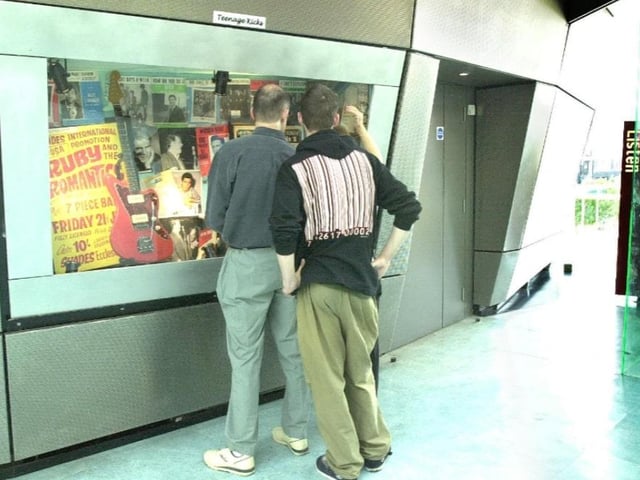 Visitors look at exhibits on the last day of opening in 2000.