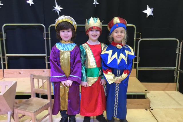 These three adorable schoolchildren are practicing for their roles as the three wise men in vibrant and vivid colors in the nativity Christmas play at St John Fisher school